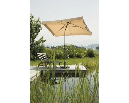 Gartenszene mit Sonnenschirm und Liegestuhl auf Holzterrasse am Teich