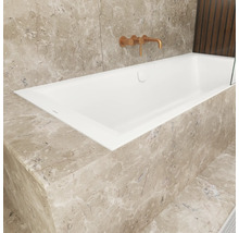 Eingebaute Badewanne mit Armatur an gefliester Wand