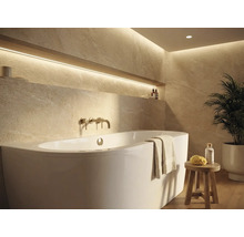 Helles Badezimmer mit Badewanne, Armatur und Ablagefläche mit Dekoration