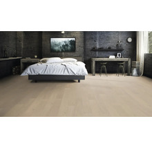 Schlafzimmer mit Bett, Schreibtisch und hellem Holzboden