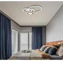 Schlafzimmer mit modernem Design und kreisförmiger LED Deckenleuchte.