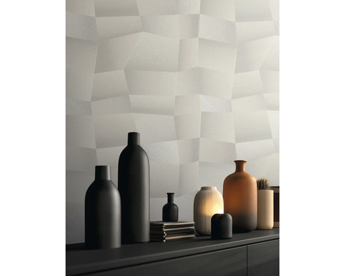 Moderne Strukturtapete mit dreidimensionalem Polygon-Muster in Hellgrau, dekoriert mit verschiedenen Vasen auf einem Sideboard.