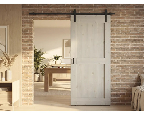 Holzschiebetür vor Backsteinwand in modernem Wohnraum