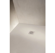 Detailansicht einer weißen Duschwanne mit einer quadratischen Ablaufabdeckung mit Sternmuster und Laufen Logo.
