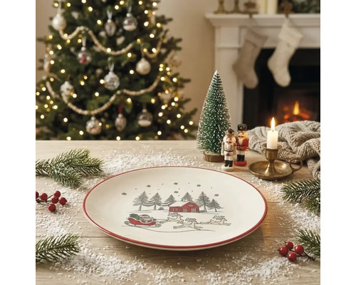 Weißer Weihnachtsteller mit rotem Rand und Illustration von Weihnachtsmann im Schlitten, Tannen und Haus in einer festlichen Wohnraumumgebung.