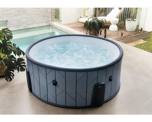 Runder aufblasbarer Whirlpool mit geometrischem Muster und sprudelndem Wasser auf einer hellen Terrasse neben einem Pool und Holzdeck.