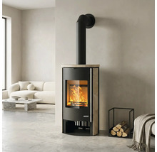 Kaminofen mit Natursteinverkleidung und brennendem Feuer in einem hellen, modernen Wohnzimmer mit weißem Sofa.