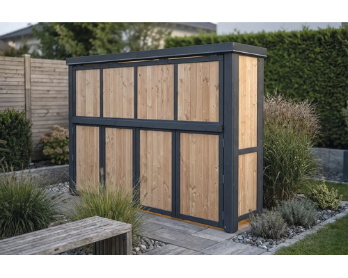 Moderne Mülltonnenbox aus Holz mit anthrazitfarbenem Rahmen in einem Garten mit Pflanzen und Kies.