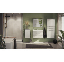 Modernes Badezimmer mit weißen Möbeln, grüner Wand, ebenerdiger Dusche mit schwarzem Rahmen, Badewanne und beleuchtetem Spiegel über dem Waschtisch.