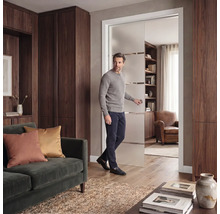 Moderne Glasschiebetür aus Milchglas mit Querstreifen in einem eleganten Wohnzimmer mit dunklen Holzschränken und Samtsofa.