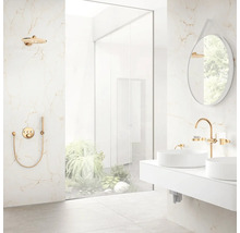 Modernes helles Badezimmer mit Marmoroptik-Fliesen, Doppelwaschtisch mit goldenen Armaturen und begehbarer Dusche mit Blick auf Pflanzen.