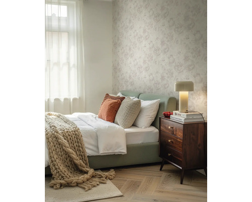 Vliestapete mit Blumenmuster in einem hellen Schlafzimmer mit Holznachttisch und Parkettboden.