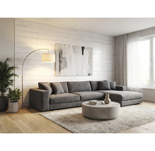 Helles Wohnzimmer mit grauer Eckcouch, rundem Couchtisch, Bogenlampe und weißer Holzwand. Moderner Stil mit Parkettboden und Teppich.