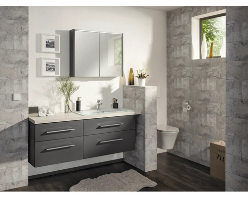 Modernes Badezimmer mit dunkelgrauem Waschtischunterschrank, weißem Waschbecken, Spiegelschrank und grauen Wandfliesen in Steinoptik.