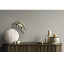 Tapete mit Leinenstruktur an einer Wand hinter einem Sideboard mit dekorativen Vasen und Schalen.