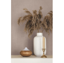 Tapete mit Leinenstruktur, dekoriert mit einer weißen geriffelten Vase mit Trockengras, einem Aroma Diffuser in Holzoptik und einem Kerzenständer.