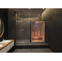 Moderner Wellnessbereich mit Infrarotkabine aus hellem Holz, einer Walk-in-Dusche mit Glaswänden und dunklen großformatigen Fliesen.