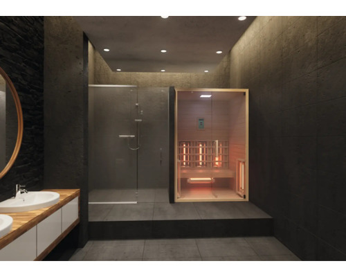 Moderner Wellnessbereich mit Infrarotkabine aus hellem Holz, einer Walk-in-Dusche mit Glaswänden und dunklen großformatigen Fliesen.