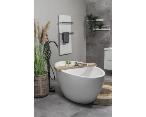 Helles, modernes Badezimmer mit freistehender, weißer Badewanne, schwarzer Standarmatur, Handtuchheizkörper und dekorativen Elementen aus Holz.