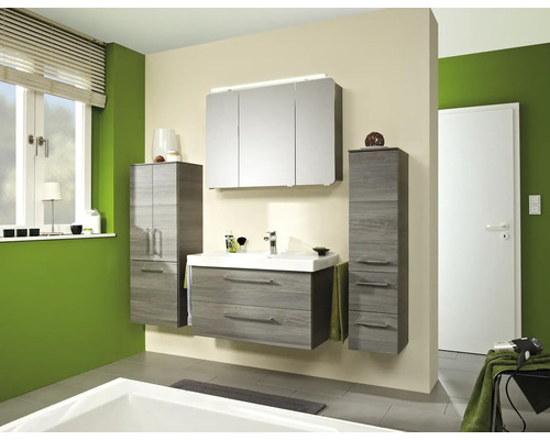 Modernes Badezimmermöbel-Set in Holzoptik bestehend aus Waschtisch mit Unterschrank, Spiegelschrank mit Beleuchtung und zwei Hochschränken.