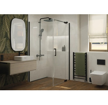 Modernes Badezimmer mit Glasduschkabine, wandhängendem Waschbecken, ovalem Spiegel und hängender Toilette vor einer Wand mit Blattmotiv.