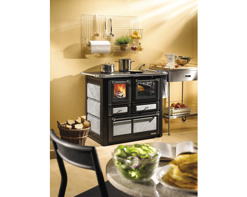 Küchenszene mit Holzofen, Kochgeschirr und Speisen auf dem Tisch