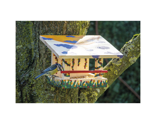 Vogelhaus aus Holz mit Futter und Blaumeise auf einem Baum