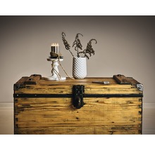 Dekorative Szene mit einer Holzkiste, einer Vase mit Pflanzen und einem Kerzenständer mit Kerzen
