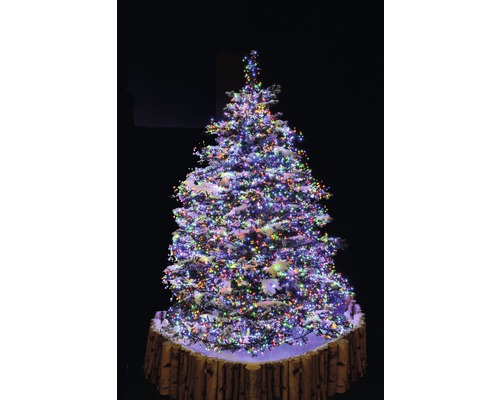 Weihnachtsbaum mit mehrfarbiger Beleuchtung und Baumständer in Holzoptik