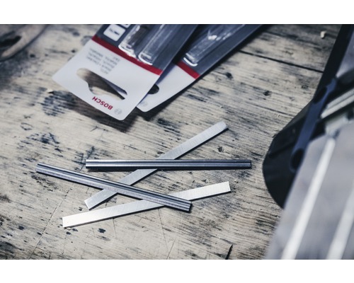 Bosch Logo, Hobelmesser und Verpackung auf einem Holztisch