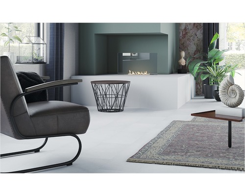 Helles Wohnzimmer mit Sessel, Kamin und dekorativen Elementen