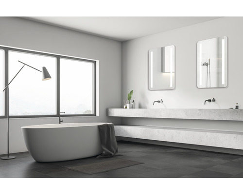 Helles Badezimmer mit Badewanne, Waschtisch und Spiegeln