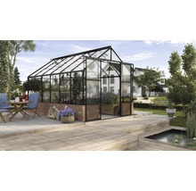 Gewächshaus mit Glaswänden und Ziegelbasis im Garten