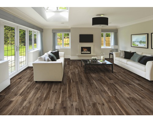 Heller Wohnraum mit braunem Holzboden, weißen Sofas und Kamin.