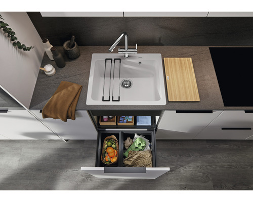 Küchenspüle mit Armatur, Schneidebrett und Mülltrennsystem in einer modernen Küche