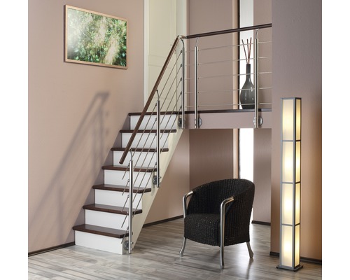 Innenraum mit Treppe, Sessel und Stehlampe.