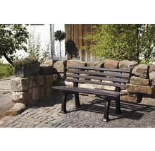 Gartenbank aus Metall vor Steinmauer