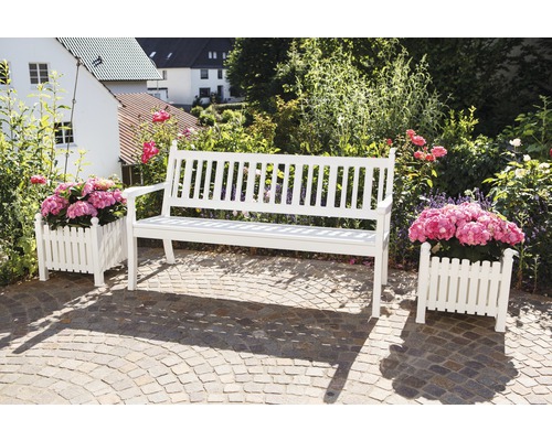 Garten Szene mit einer weißen Gartenbank aus Holz und zwei Blumenkästen mit Pflanzen