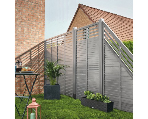 Garten mit Sichtschutzzaun, Pflanzgefäßen und Gartentisch