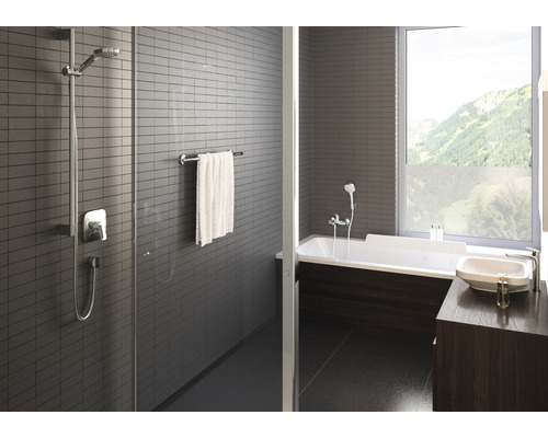 Modernes Badezimmer mit Dusche, Badewanne, Waschbecken und Fenster mit Bergblick
