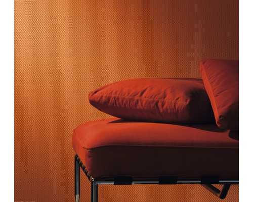 Nahaufnahme einer strukturierten Tapete und eines Sofas mit Kissen