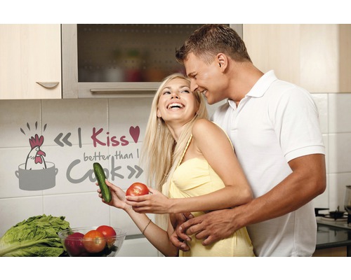 Paar in Küche mit Wandtattoo und Gemüse