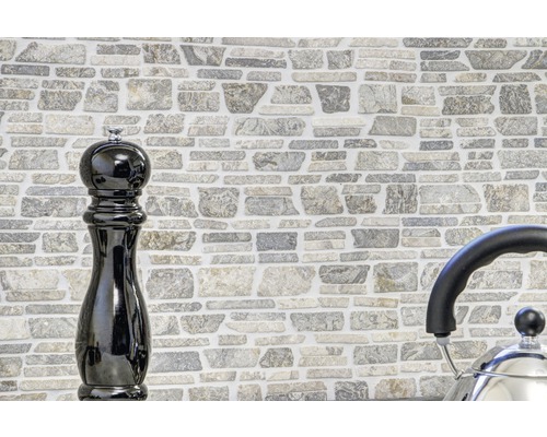 Mauer aus Steinimitat mit Pfeffermühle und Wasserkocher