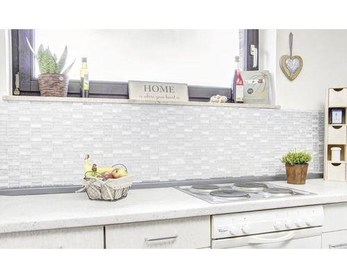 Helle Küche mit Mosaikfliesen, Obstschale und Kochfeld