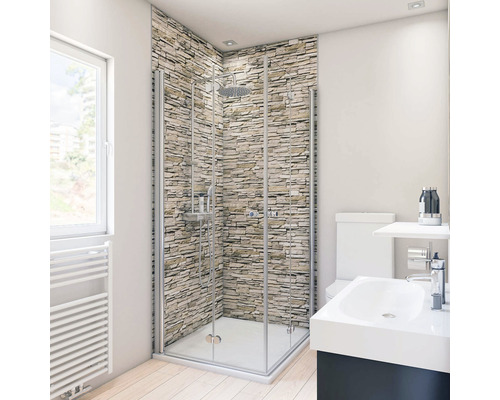 Duschrückwand Breuer Decodesign 1500x2550x3 mm Mauer Optik hell Badezimmer mit Duschkabine, Waschtisch und Toilette vor einer Steinwand