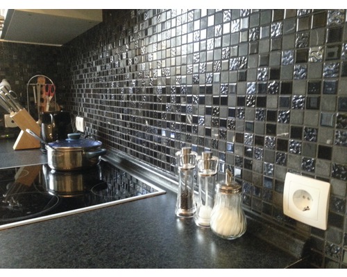 Küchenszene mit Mosaikfliesen, Kochfeld, Töpfen und Küchenutensilien