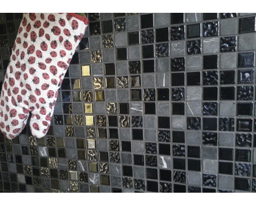 Mosaikfliesenwand mit einem Topflappen mit Marienkäfermuster.