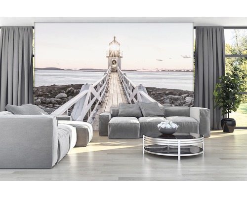 Wohnzimmer mit Fototapete eines Leuchtturms über einem Steg am Meer