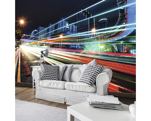Wohnzimmer mit Fototapete einer nächtlichen Stadtlandschaft mit Lichtern und Hochhäusern