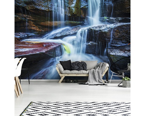 Wohnzimmer mit Fototapete eines Wasserfalls, Sofa und Teppich